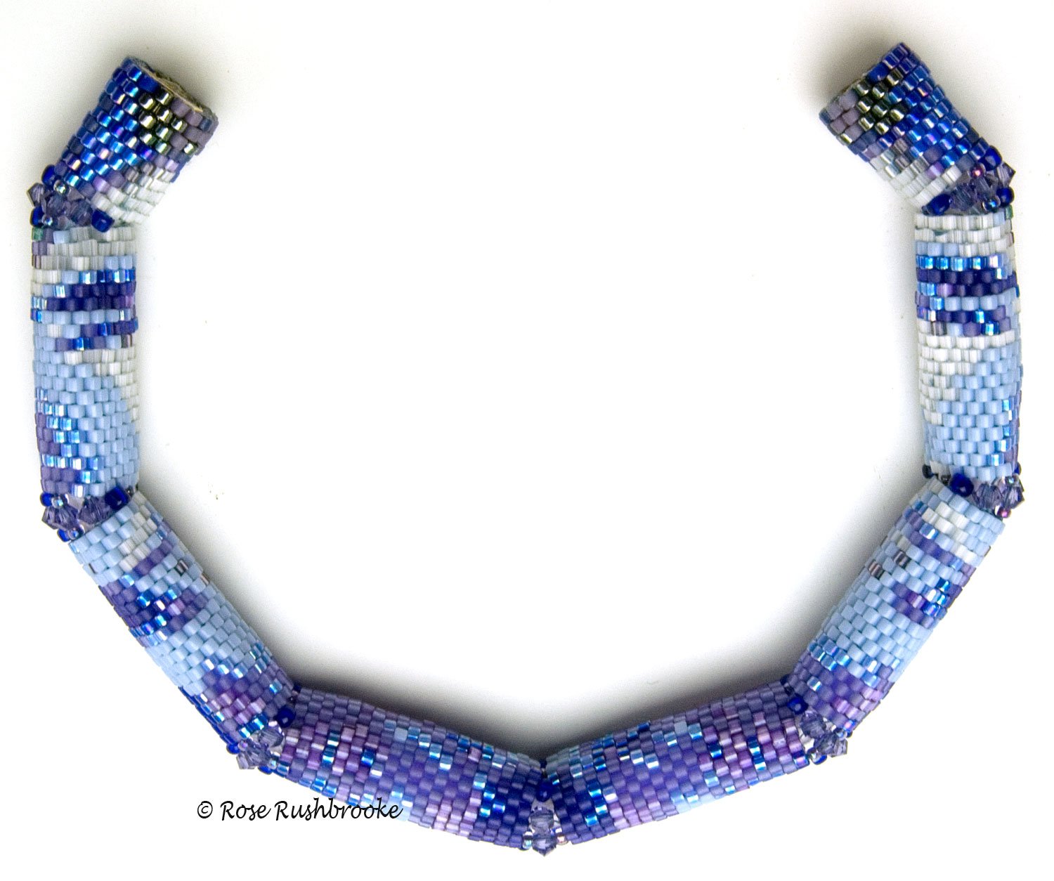 Close up of Triangles and Squares necklace clasp by Rose C Rushbrooke. Seafoam and cream beaded beads, pale blue dyed pearls, green opal chips, pink rondelles glass beads, and mint pressed glass beads. Peyote stitch beadweaving. Image copyright &copy; Rose C Rushbrooke.