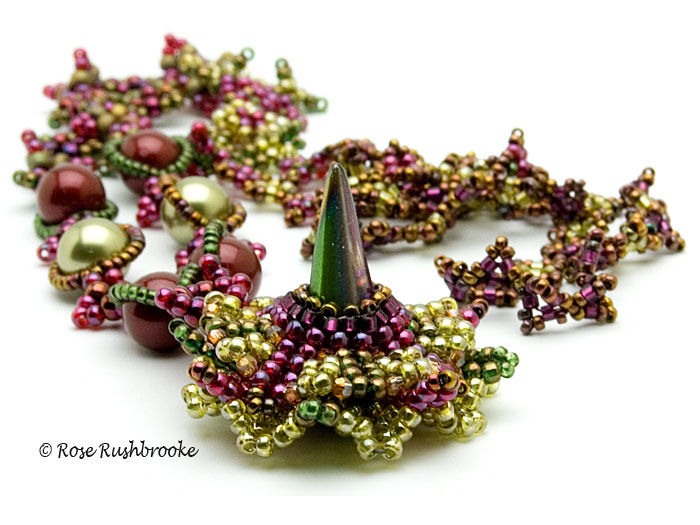 Burgundy and olive snap clasp necklace by Rose C Rushbrooke. Beadweaving - glass spike bead, Swarovski crystals and pearls, and seed beads. Image copyright &copy; Rose C Rushbrooke.