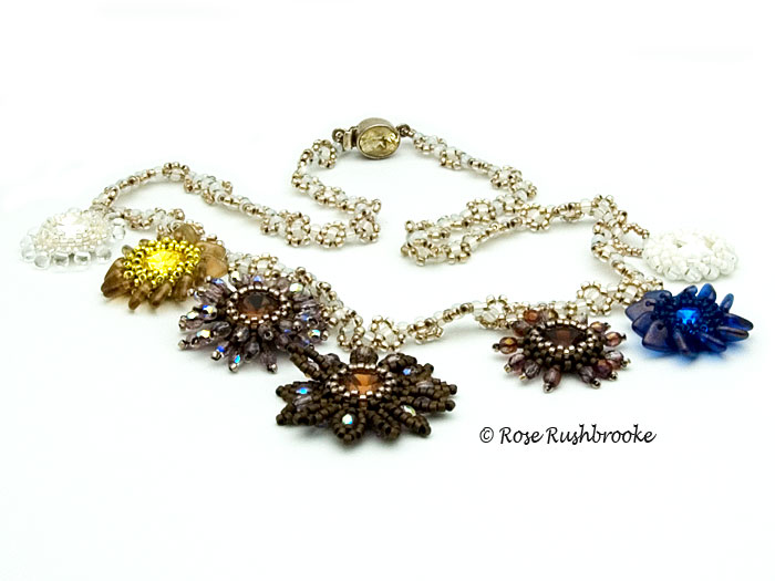 Horn of Plenty necklace - beadweaving. Made with seed beads, drops, fire polish crystals, and Swarovski rivolis. Image copyright &copy; Rose C Rushbrooke.