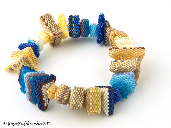 Rabbit Hole bangle by Rose C Rushbrooke. Made with delicata glass seed beads. Beadweaving - peyote stitch. Image copyright &copy; Rose C Rushbrooke.